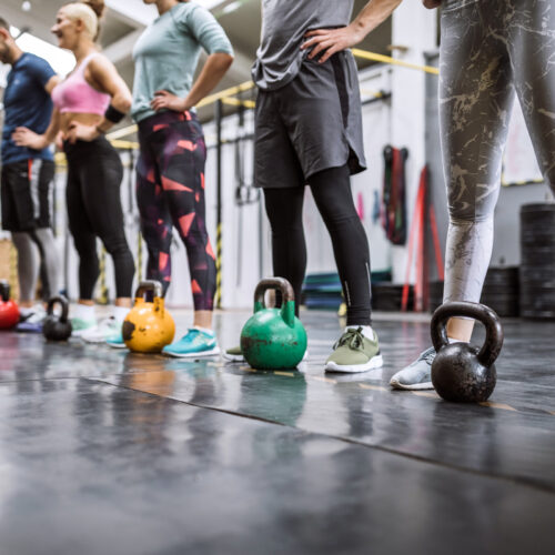 Sports people Doing Cross Training Workout In Gym